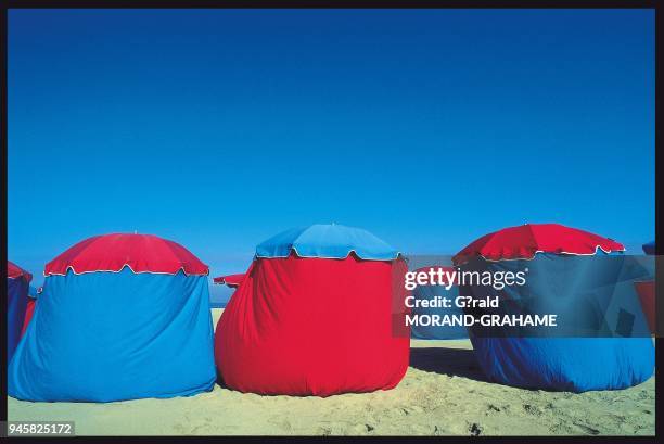 PARASOLS SUR LA PLAGE DE DEAUVILLE, NORMANDIE.