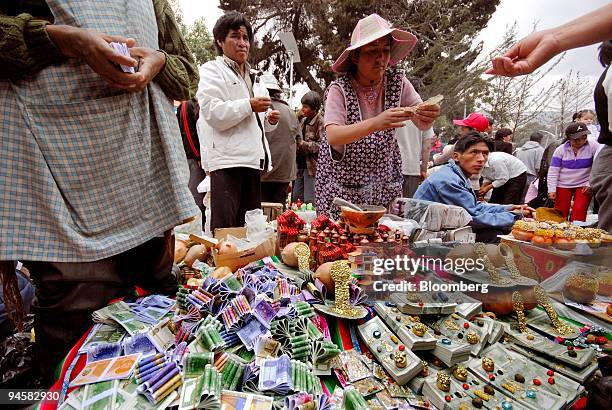 Bolivians buy reproductions of U.S. Dollars and Euros during the Alasita festival in La Paz, Bolivia, on Wednesday, January 24, 2007. The festival of...