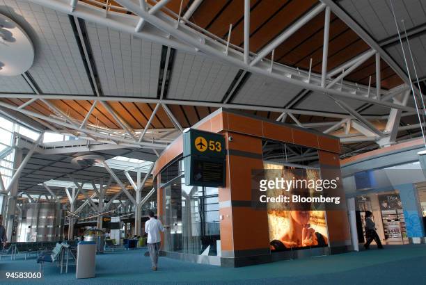 Passengers pass through the new International Terminal of Vancouver International Airport , promoted as the "Gateway to the Games," in Vancouver,...
