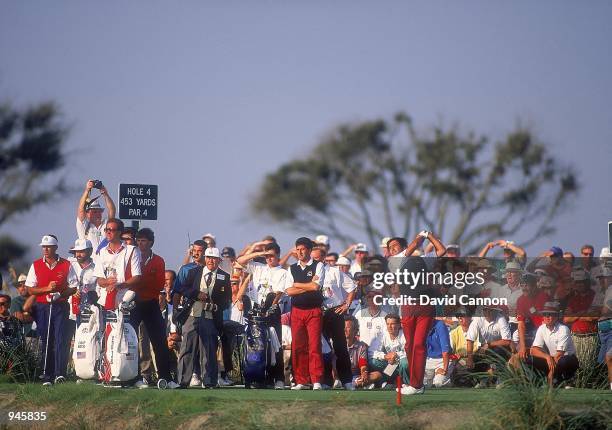 Seve Ballesteros tees off on the 4th hole watched by European team partner Jose Maria Olazabal and USA team pairing Paul Azinger and Chip Beck on Day...