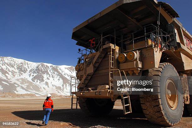 Patricia Guajardo walks near the mining truck she drives at Barrick Gold Corp.'s Veladero mine in the San Juan province of Argentina, on Tuesday,...