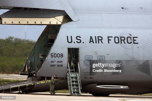 Air Force Galaxy C-5 plane at the airport in Merida, Yucatan, Mexico, unloads security personnel and equipment in advance of President George Bush's...