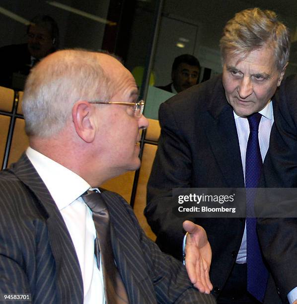 Jean-Claude Trichet, President of the European Central Bank, right, greets Dutch finance minister Gerrit Zalm, before the start of the Euro Group...