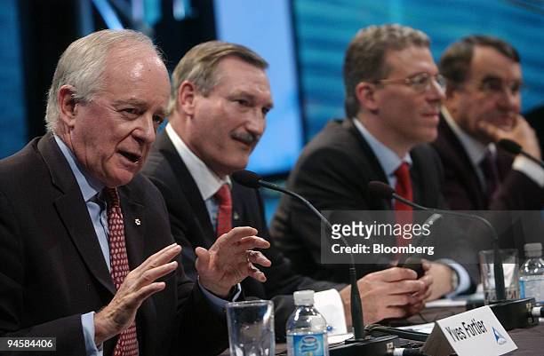 As Yves Fortier, chairman of Alcan Inc., far left, speaks, Dick Evans, chief executive officer of Alcan, Tom Albanese, chief executive office of Rio...