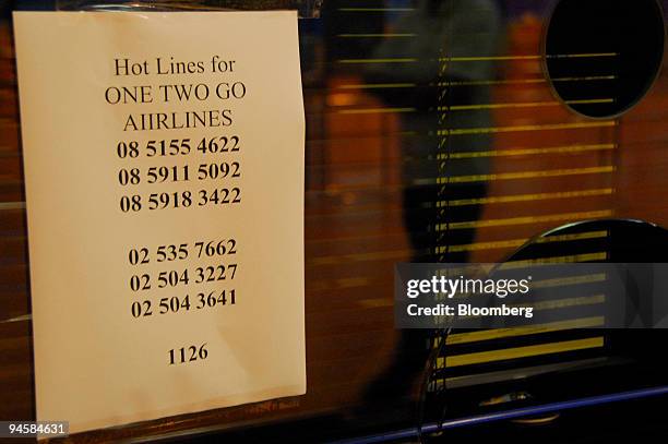 Emergency hot lines for One Two Go Orient Thai Airways are posted near their check-in counter at Don Mueang airport in Thailand, Bangkok on Sunday,...