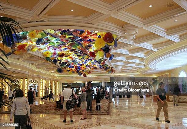 People walk through the lobby of the Bellagio Hotel and Resort in Las Vegas Tuesday, May 22, 2007. Shares of MGM Mirage rose the most ever after...