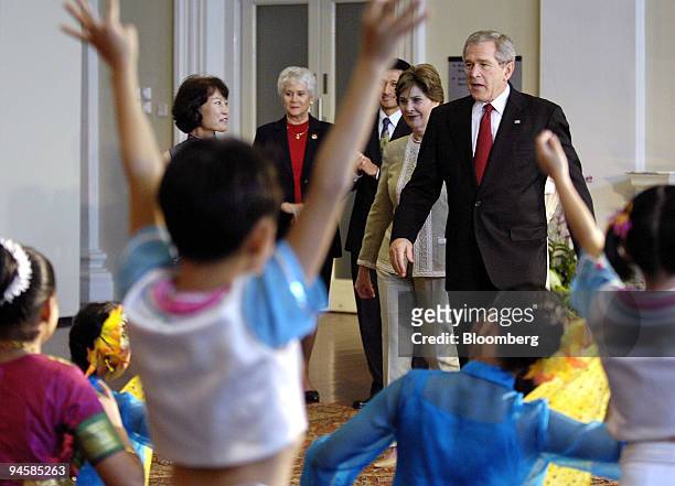 American President George W. Bush and First Lady Laura Bush watch a dance performance by school kids during their visit to the Asian Civilisation...