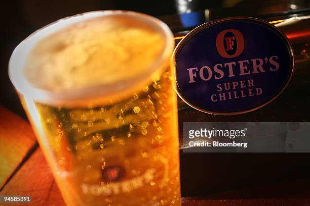 Pint of Fosters lager is arranged on a bar at the Queen's Head public house in Littlebury, Essex, on Wednesday, Oct. 17, 2007. Heineken NV, the Dutch...