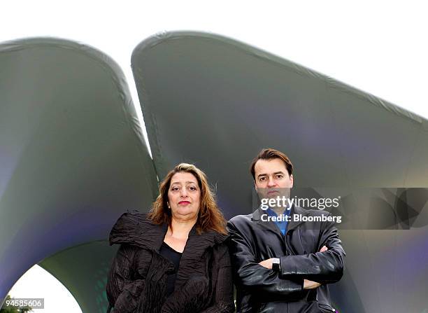 Zaha Hadid, left, and Patrik Schumacher pose in front of their installation entitled ''Lilas'' at the Serpentine Gallery, London, U.K., Wednesday,...