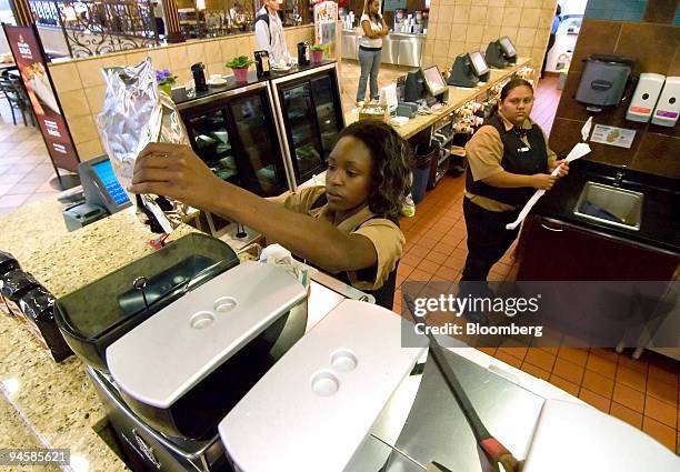 Latreva Carpenter puts a bag of coffee beans in to a brewer at a McDonald's MCCafe in Winston-Salem, North Carolina, U.S., on Friday, Sept. 14, 2007....