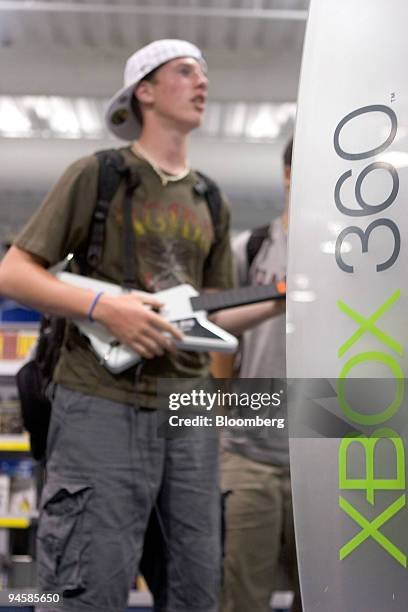 Shawn, who declined to give his last name, plays Guitar Hero II on an Xbox 360 at a Best Buy store in Cambridge, Massachusetts, Wednesday, July 11,...