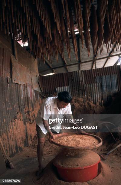 An intense period of production at an incense-stick making factory for the Chinese festival of hungry ghosts. P?riode intense de production dans une...