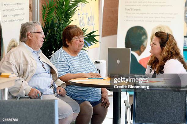 Gusto Guzman, left and his wife Gloria Guzman of Guadalupe, Arizona, talk with Connie Parra, right of El Mirage, Arizona to see if they need to make...