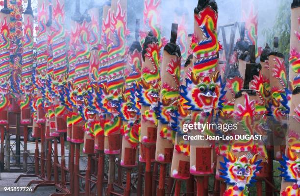 Large sticks of incense are burned for ghosts during the Chinese festival of famished ghosts. Poteaux d'encens qui seront br?l?s pour les fant?mes...
