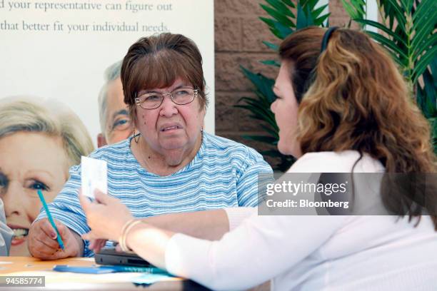 Gloria Guzman, left, 68 of Guadalupe, Arizona talks with Connie Parra, 47 of El Mirage, Arizona to see if she needs to make any changes to her...