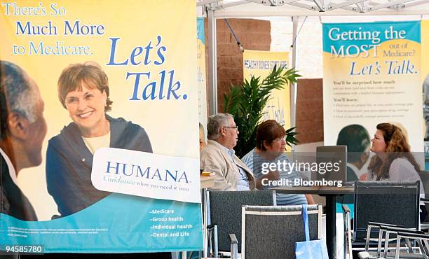 Gusto Guzman, left and his wife Gloria Guzman of Guadalupe, Arizona, talk with Connie Parra, right of El Mirage, Arizona to see if they need to make...