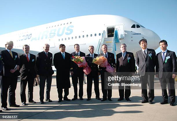 Cho Yang Ho, chief executive officer of Korea Air, forth from left, poses in front of the Airbus A380 with employees of Airbus and Korea Air at the...