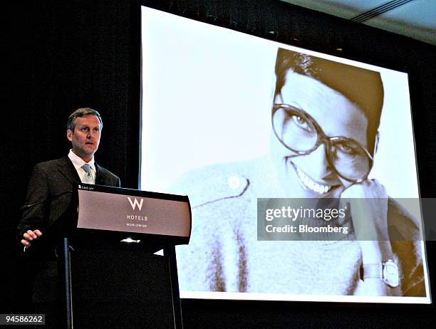 Liz Claiborne, the designer and founder of the namesake clothing company, appears on a screen as William McComb, chief executive officer of Liz...