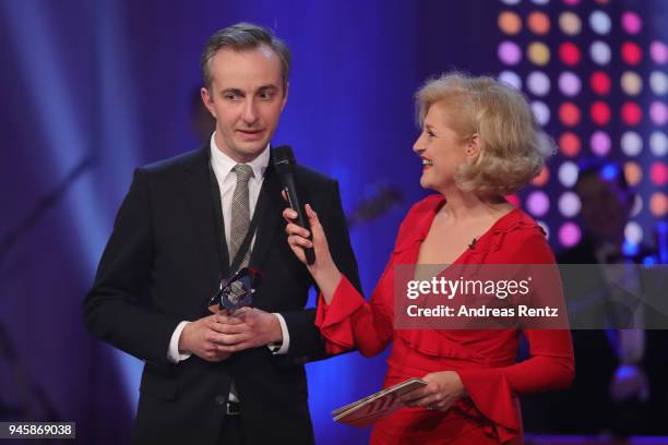 Award winner Jan Boehmermann chats with host Annette Gerlach during the 54th Grimme Award on April 13, 2018 in Marl, Germany.