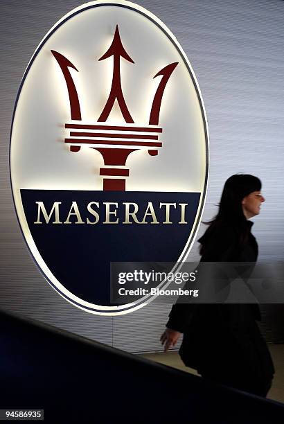 An employee passes the Maserati logo in the Maserati headquarters' showroom in Modena, Italy, Tuesday, March 20, 2007. Look into the cockpit of a...