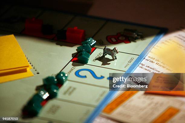 Game piece sits on the board game Monopoly, manufactured by Hasbro Inc., at the New York University Real Estate Institute Monopoly event on Tuesday,...
