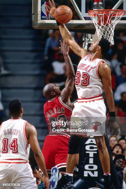 Alonzo Mourning of the Miami Heat blocks the shot by Michael Jordan of the Chicago Bulls during the game on February 23, 1996 at the Miami Arena in...