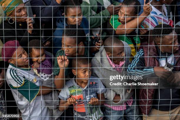 People line the streets as the body of Winnie Mandela is returned to her home in Soweto the day before the funeral for the anti-apartheid icon on...