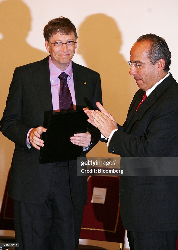 Microsoft Chairman Bill Gates, left, receives the "Aztec Eag