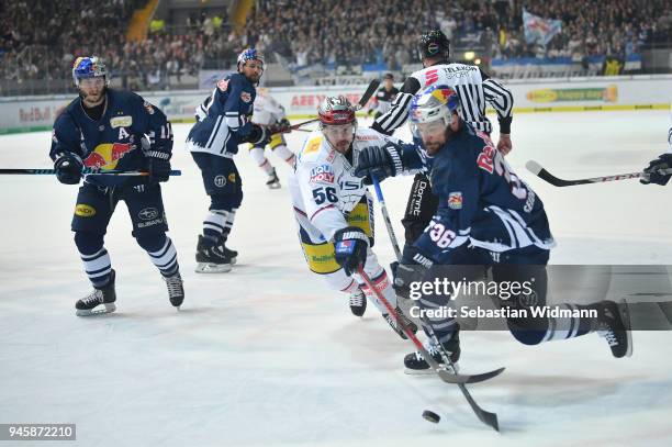 Martin Buchwieser of Berlin and Yannic Seidenberg of EHC Muenchen compete for the puck during the DEL Playoff Final Game 1 between EHC Red Bull...