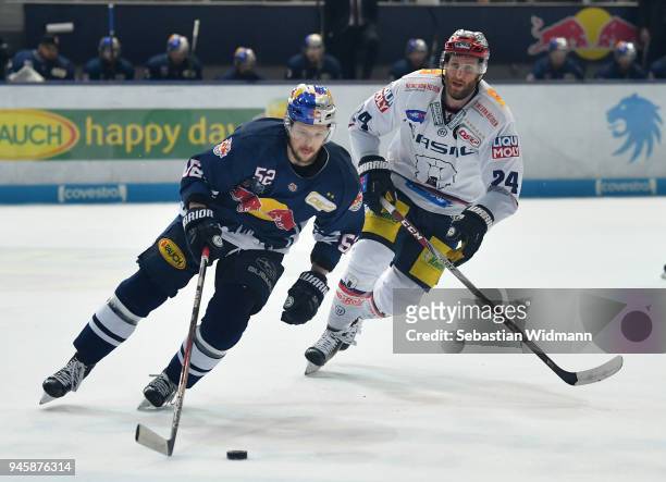 Patrick Hager of EHC Muenchen and Andre Rankel of Berlin compete for the puck during the DEL Playoff Final Game 1 between EHC Red Bull Muenchen and...