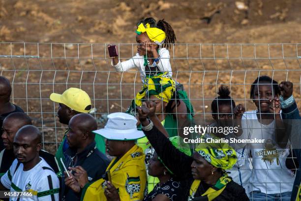 Young girl looks on as the body of Winnie Mandela is returned to her home in Soweto the day before the funeral for the anti-apartheid icon on April...