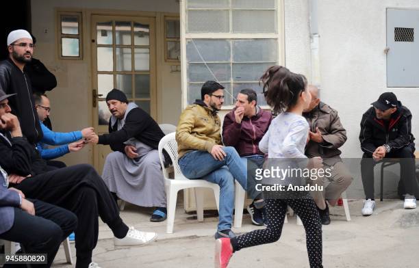 Relatives of Algerian co-pilot Sadiki Mohrez, who died during the plane crash, are seen in front of a house to pay their condolences in Algiers,...