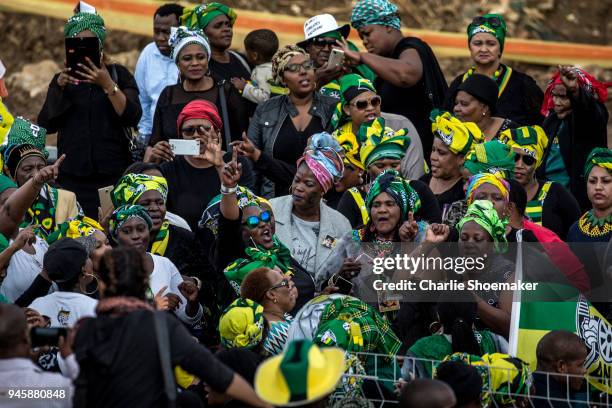 People react as the body of Winnie Mandela is returned to her home in Soweto the day before the funeral for the anti-apartheid icon on April 13, 2018...