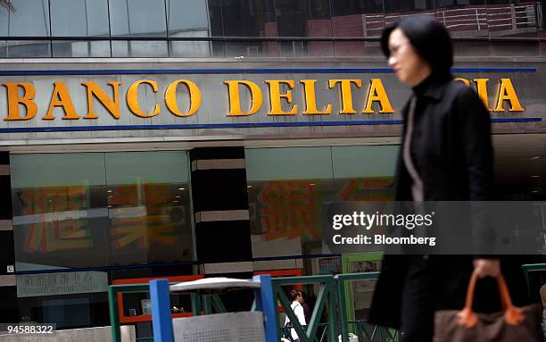 Woman walks past a branch of Banco Delta Asia SARL in Macau, China, on Wednesday, March 14, 2007. Macau authorities released $25 million in frozen...