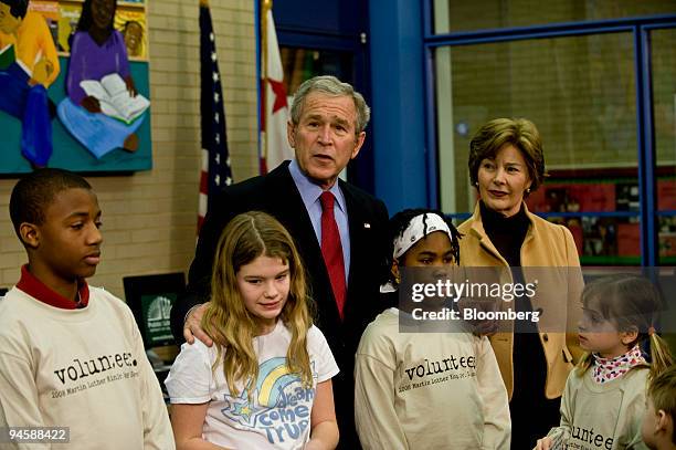 President George W. Bush, back left, and First Lady Laura Bush, visit with school children, at the Martin Luther King Jr. Memorial Library in...