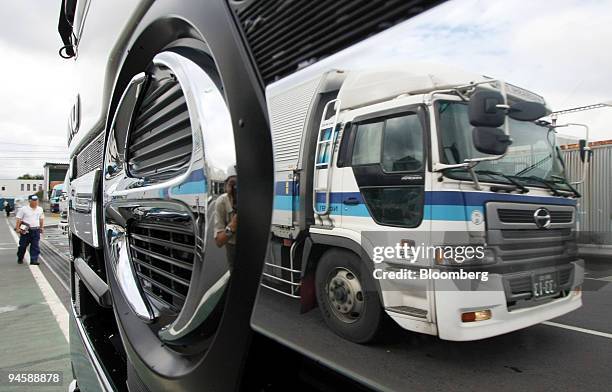 Hino Motors Ltd. Truck is reflected on another at the company's manufacturing headquarters in the suburbs of Tokyo, Japan on Wednesday, Sept. 12,...