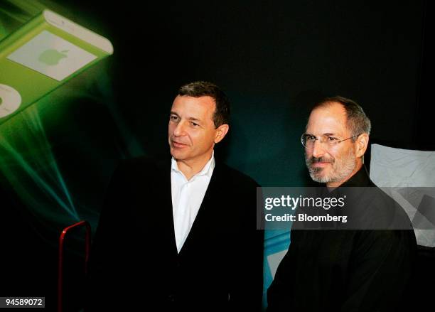 Robert Iger, left, president and chief executive officer of Walt Disney Co., poses with Steve Jobs, chief executive officer of Apple Computer Inc.,...