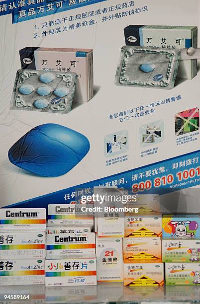 Poster for Pfizer Inc.'s erectile dysfunction medication, Viagra, and a selection of Western vitamins are displayed at a pharmacy in Beijing, China,...