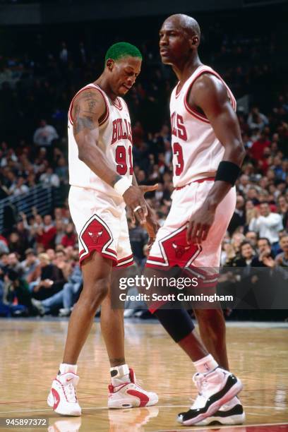 Dennis Rodman and Michael Jordan of the Chicago Bulls during the game against the New York Knicks on December 6, 1995 at the United Center in...