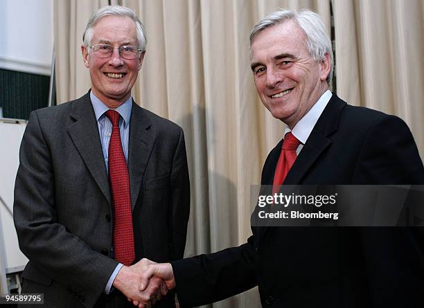 Labour Party lawmakers Michael Meacher, left, and John McDonnell, now the sole challenger of Gordon Brown for the position of prime minister, shake...