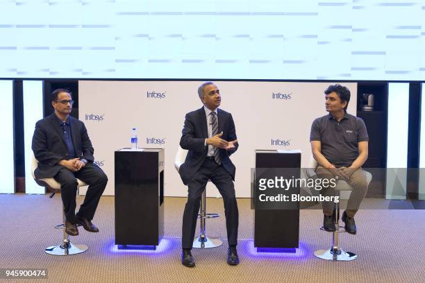 Salil Parekh, chief executive officer of Infosys Ltd., center, speaks as Pravin Rao, chief operating officer of Infosys Ltd., left, and Ranganath D....