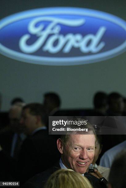 Alan Mulally, president and CEO, Ford Motor Co., talks with reporters after the unveiling of the Ford Escape and Mercury Mariner at the Ford Motor...