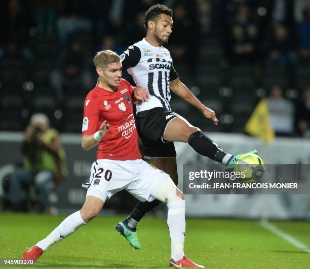 Nice's French defender Maxime Le Marchand vies with Angers' French midfielder Angelo Fulgini during the French L1 Football match between Angers and...