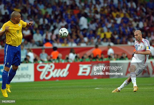 French player Zinedine Zidane, right kicks the ball as Brazilian player Ronaldo tries to block it during the 2006 FIFA World Cup Brazil versus France...