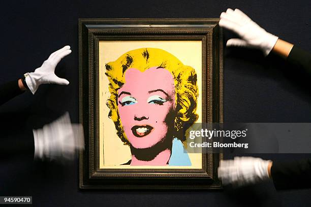 Chrisites employees straighten ''Lemon Marilyn'' by Andy Warhol from 1962 at Christies in London, U.K., Monday, March 19, 2007. The painting is up...