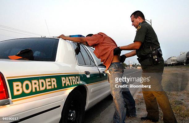 Border Patrol agent Eric Castillo searches a suspected illegal immigrant, in Harlingen, Texas on June 27, 2006. The suspected illegal immigrant,...