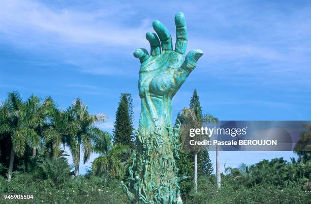 Gigantic bronze arm tattooed with a number from Auschwitz rises towards the sky, thereby representing life dying out. Along the arm are statues of...