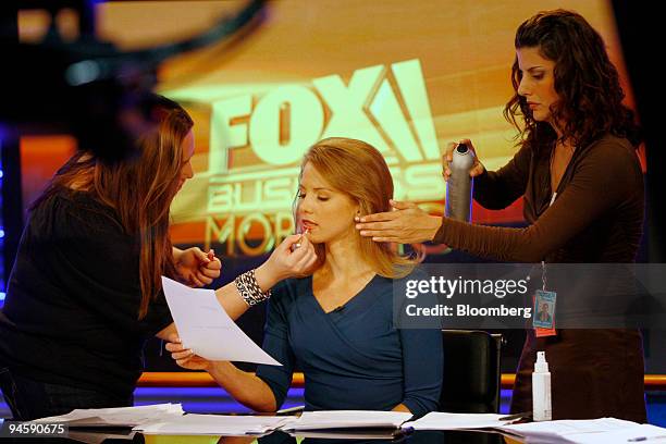 Anchor Jenna Lee has makeup and hairspray applied before the debut of the Fox Business Network at the News Corp. Headquarters in New York, U.S., on...