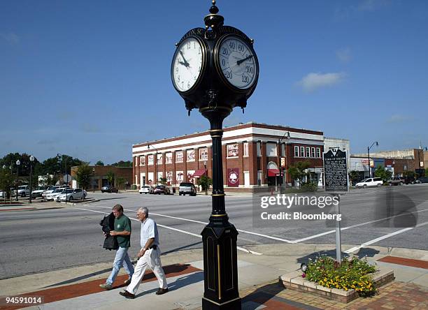 Pedestrians walk in downtown Dillon, South Carolina, Monday, August 28, 2006. Federal Reserve Chairman Ben S. Bernanke told Congress in July that he...