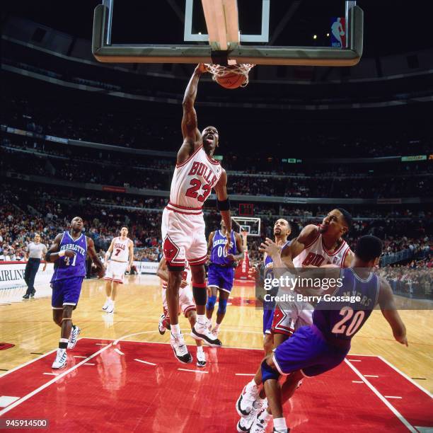 Michael Jordan of the Chicago Bulls dunks the ball against the Charlotte Hornets on April 8, 1996 at the United Center in Chicago, Illiniois. NOTE TO...